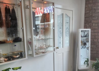 Elegant shelving in Hartley Mee Ltd, Southport, England, GB showcasing hair extensions and beauty products.