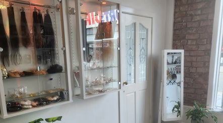 Elegant shelving in Hartley Mee Ltd, Southport, England, GB showcasing hair extensions and beauty products.