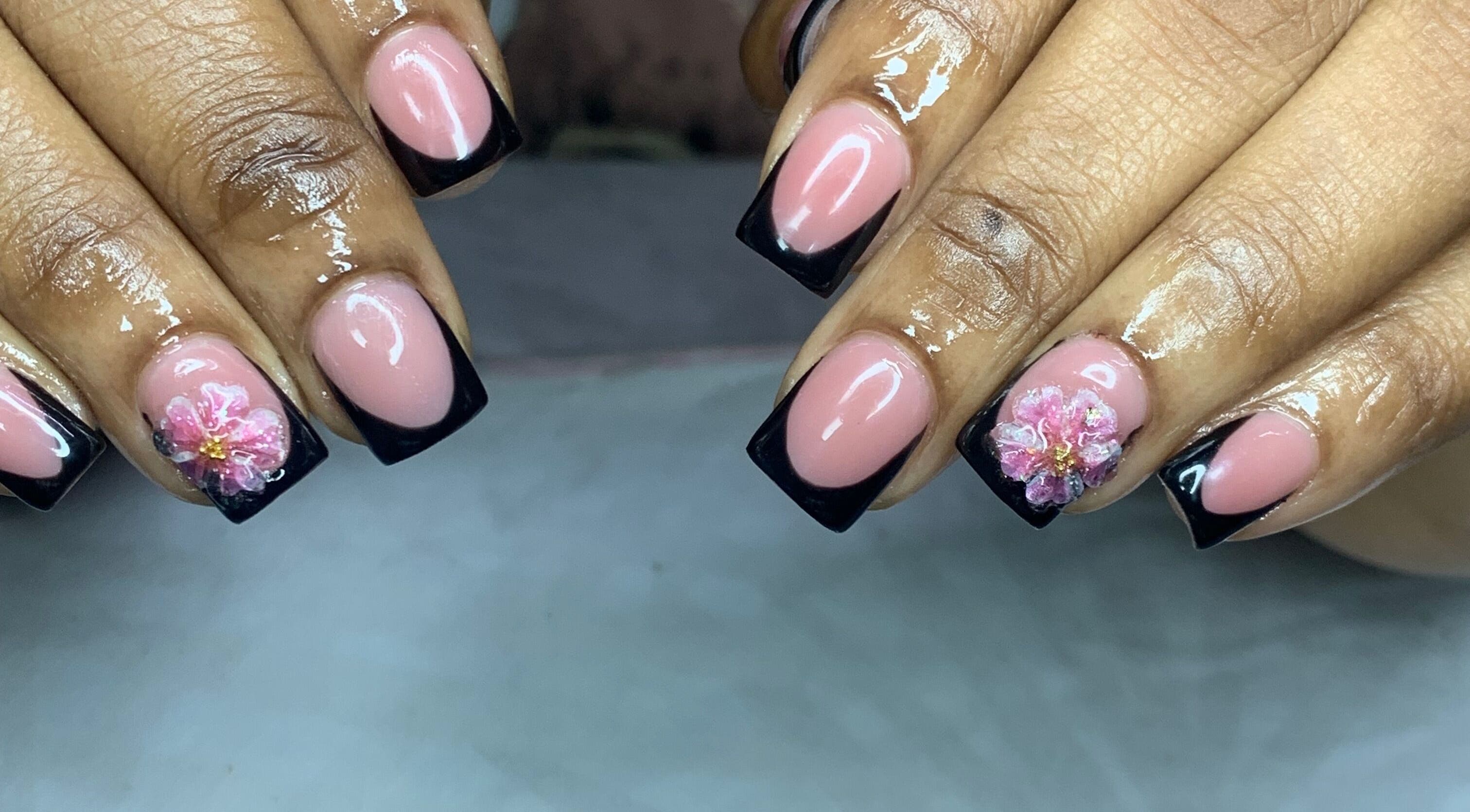 Elegant nails with black French tips and flower art at Venomcave, Paramaribo, Paramaribo, SR.