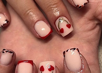 Heart-themed nail art at The Nail Studio.By Grace, Nantwich, England, GB showcasing intricate red designs.
