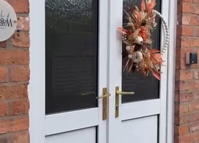 Entrance of The Nail Studio.By Grace in Nantwich, England, GB with stylish decor and elegant wreath.
