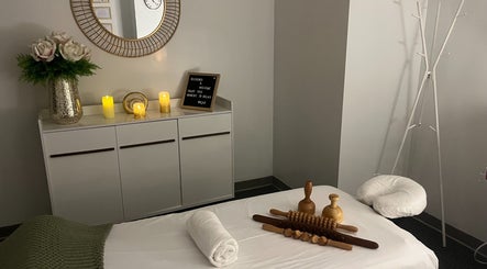 Relaxing massage room at Self Care Spa - Wellness & Bodywork in Houston, Texas, US with candles and decor.