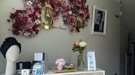 Floura Clinic's elegant reception in London, England, GB adorned with floral decor and beauty products.