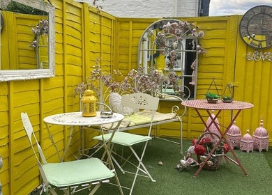 Charming yellow patio at Floura Clinic, London, England, GB with seating and decorations.