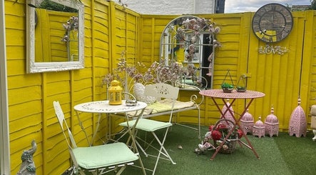 Charming yellow patio at Floura Clinic, London, England, GB with seating and decorations.