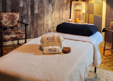 Cozy massage room at Maison Rustik, Sainte-thérèse, Québec, CA with elegant décor and comfortable linens.