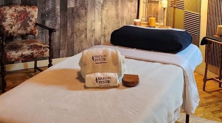 Cozy massage room at Maison Rustik, Sainte-thérèse, Québec, CA with elegant décor and comfortable linens.
