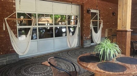 Relaxing hammock chairs on rustic patio at Maison Rustik, Sainte-Thérèse, Québec, CA.