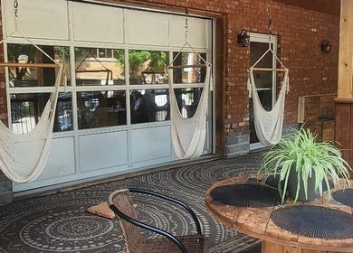 Outdoor seating with hammocks at Maison Rustik in Sainte-thérèse, Québec, CA.