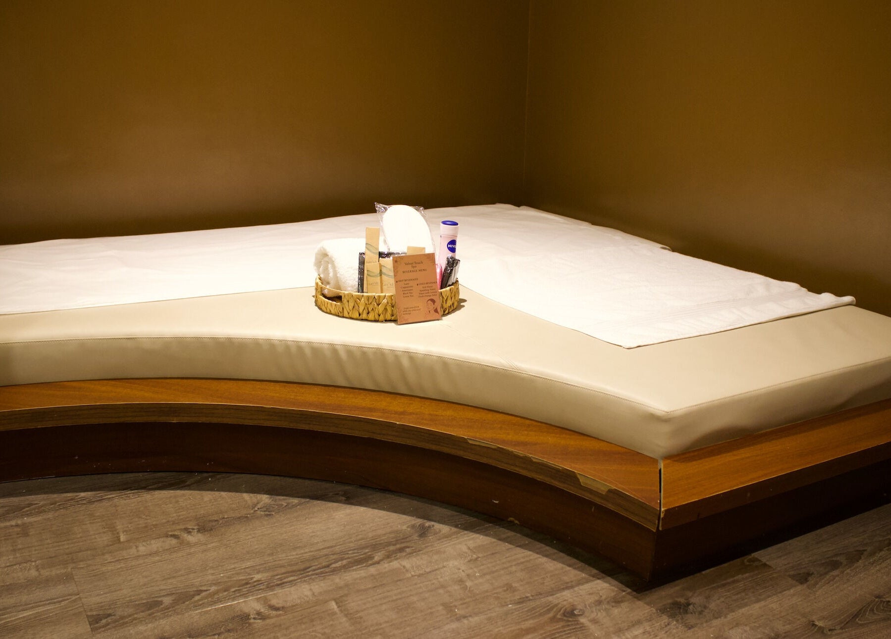Luxury massage bed at Velvet Touch European Spa, Dubai, AE, featuring elegant wooden and cream accents.