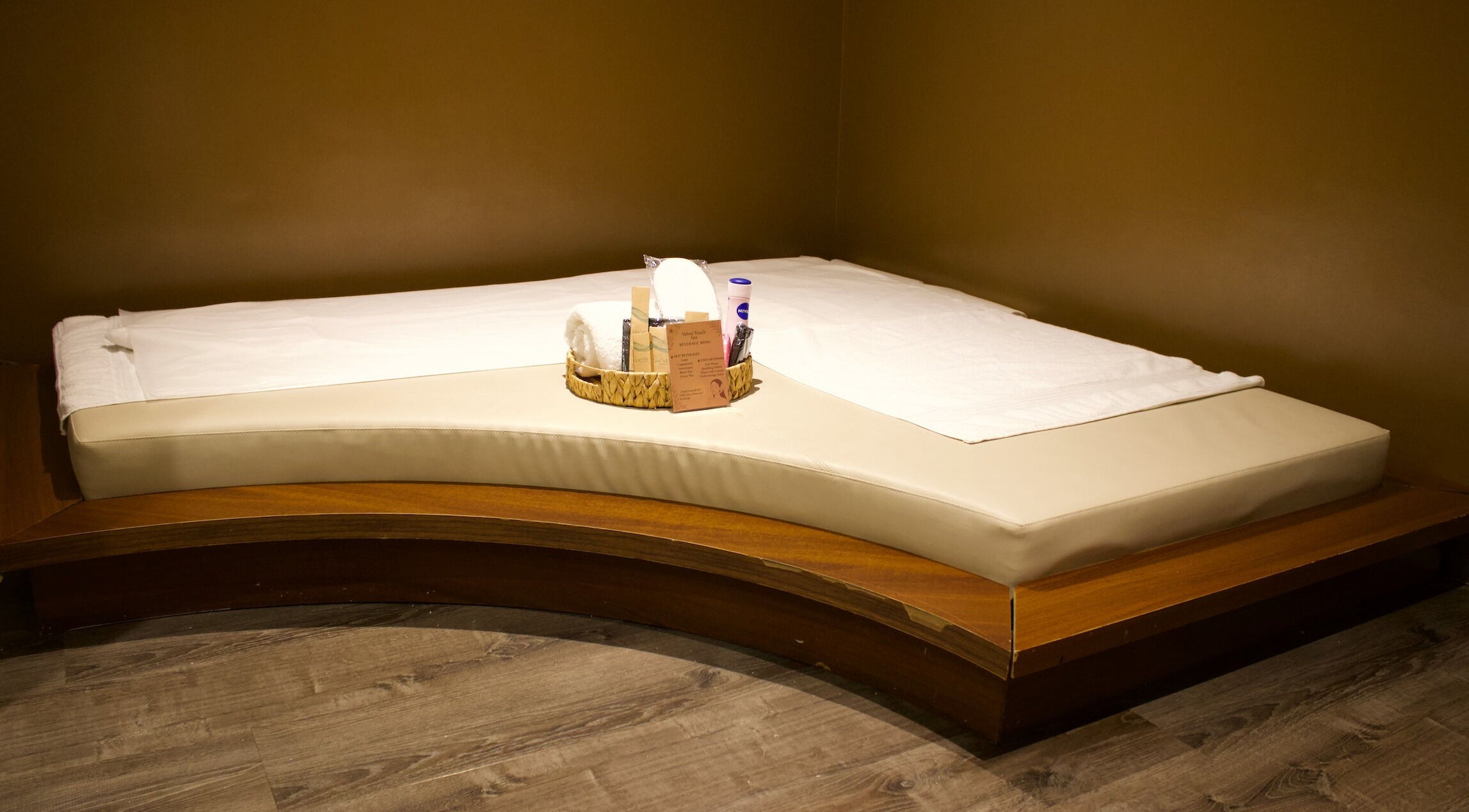 Luxury massage bed at Velvet Touch European Spa, Dubai, AE, featuring elegant wooden and cream accents.