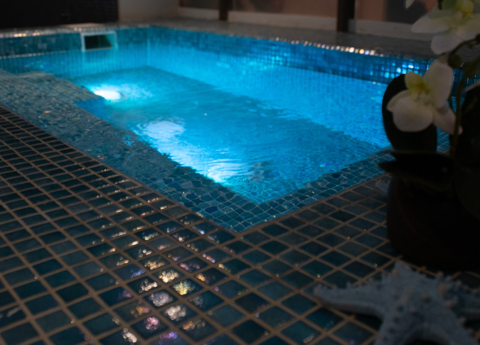 Relaxing spa pool at Velvet Touch European Spa, Dubai, AE, highlighting tranquil blue water and calming ambiance.