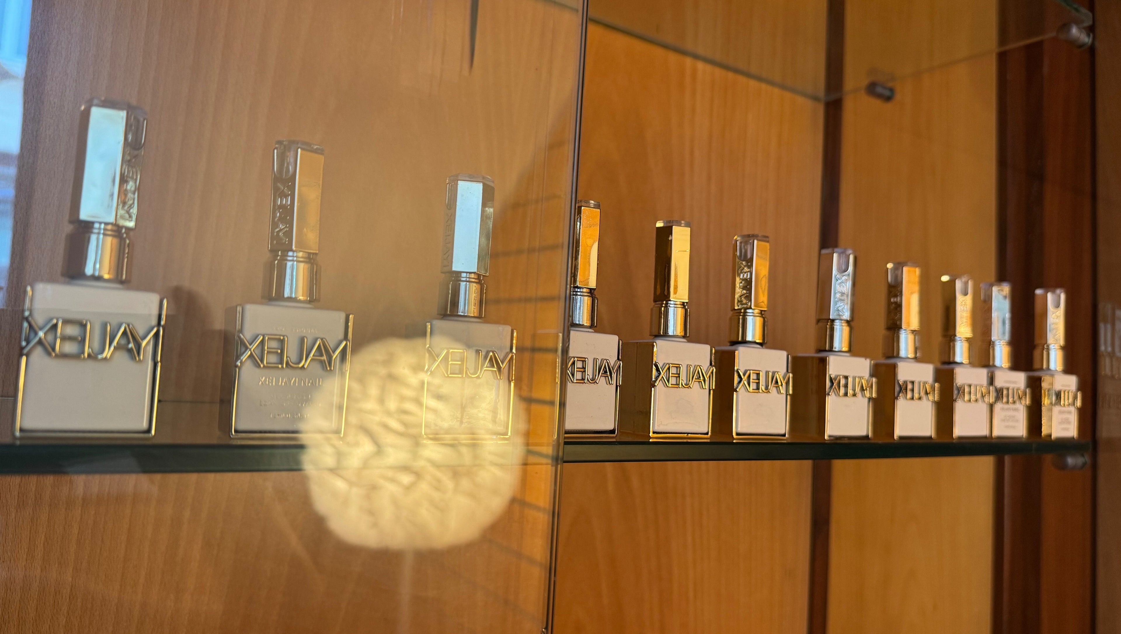 Frascos de perfume alinhados em prateleira no Karen Passos, Algés, Lisboa, PT.