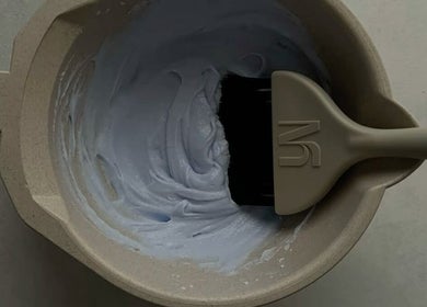 Mixing bowl with light lavender hair dye and brush at Looksbygumi, Toronto, Ontario, CA.