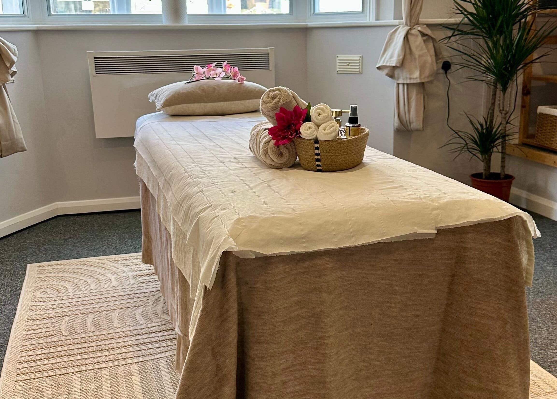 Serene massage room at UThai Massage in Sevenoaks, England, GB with relaxing decor and soft lighting.