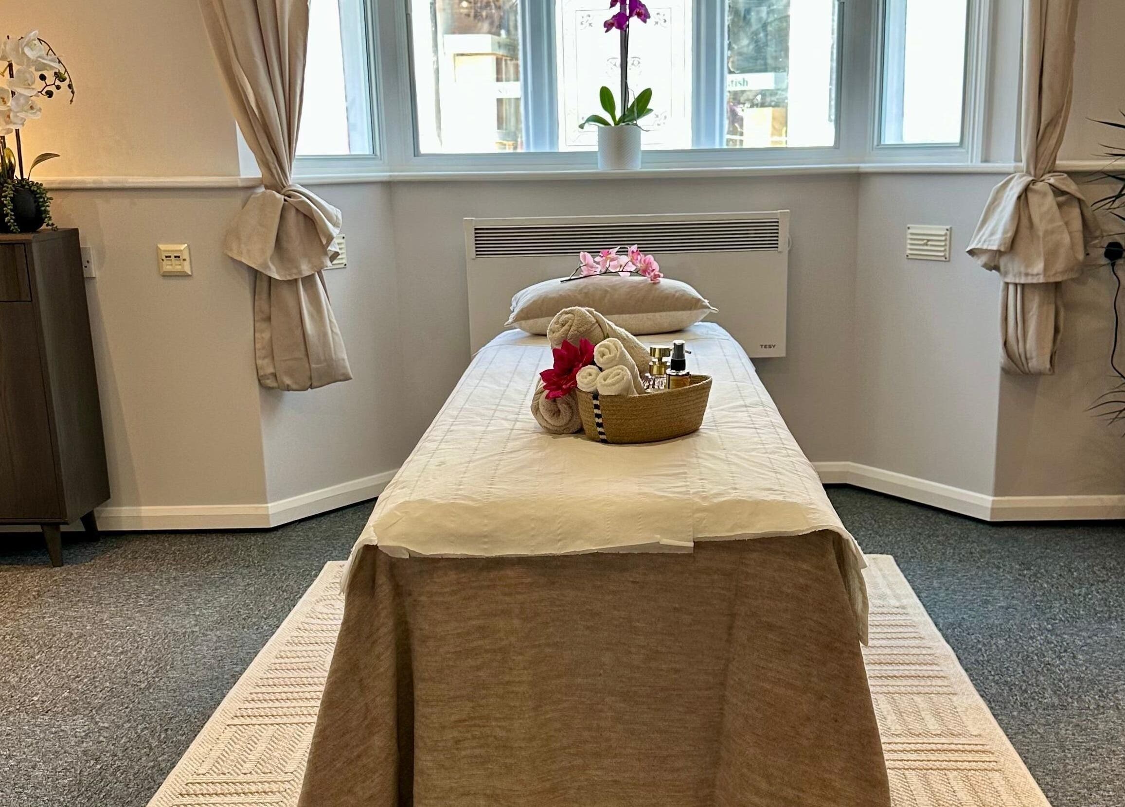 Cozy massage room at UThai Massage in Sevenoaks, England, GB featuring a treatment bed and calming decor.