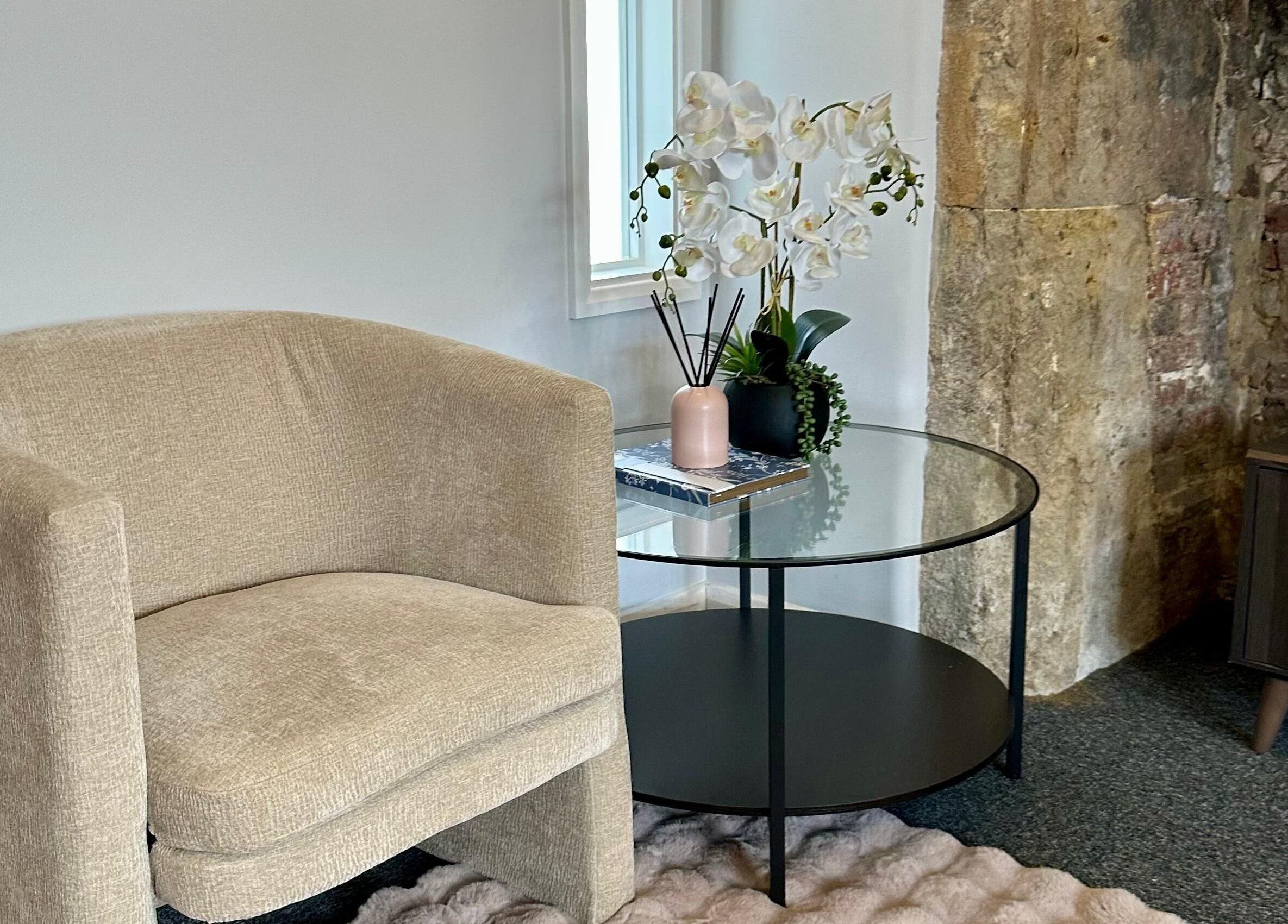 Cozy seating area with orchid at UThai Massage, Sevenoaks, England, GB.