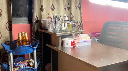 Nail station at Nails by Jada, Princes Town Regional Corporation, with tools and product display.