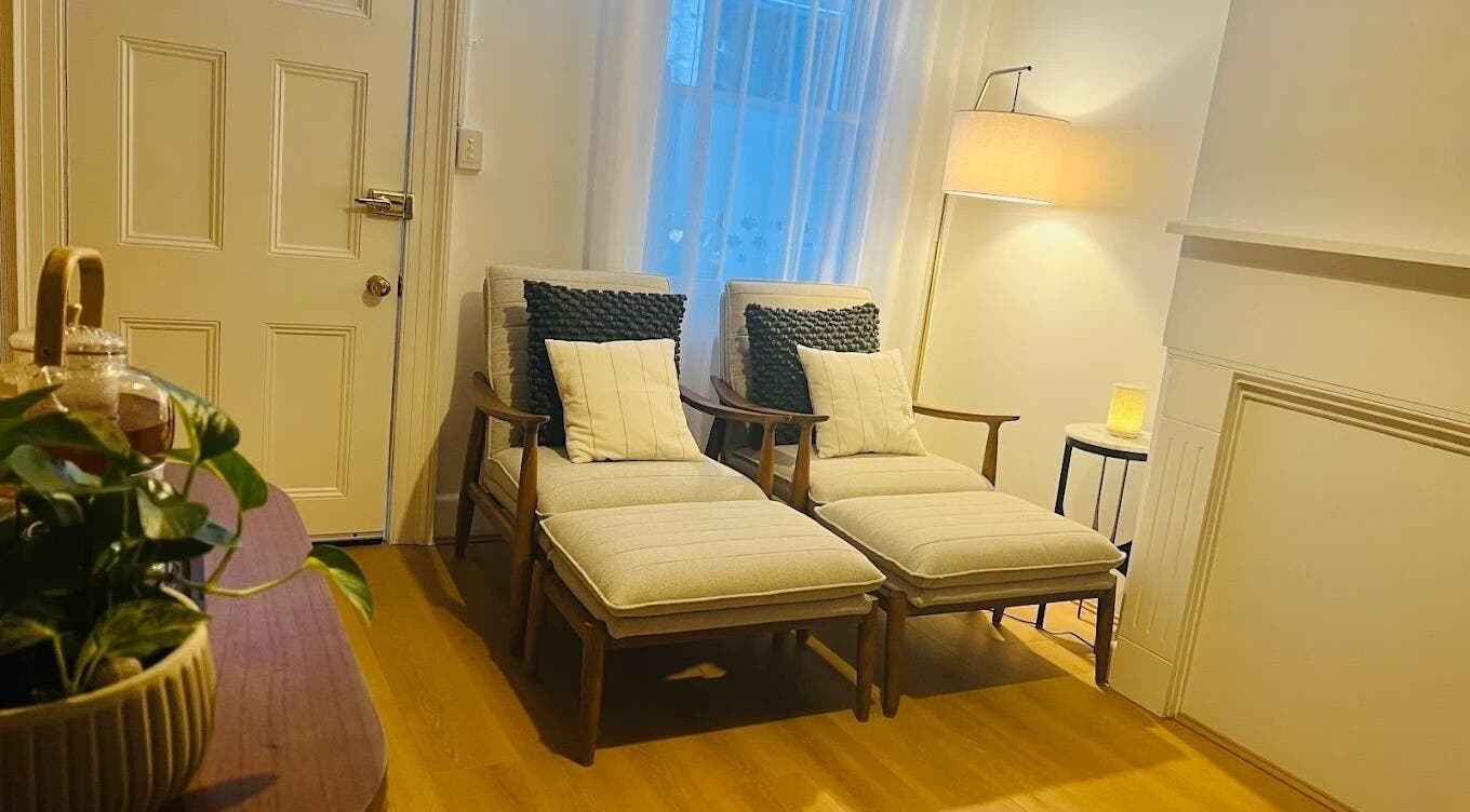 Relaxing seating area at Calm Thai Therapeutic in Chippendale, New South Wales, AU featuring plush chairs and soft lighting.
