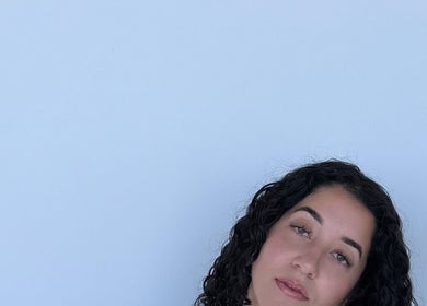 Woman with curled hair at Endless Lash Beauty Lounge, Miramar, Florida, US for a tranquil beauty experience.