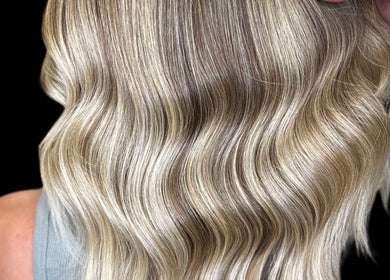 Soft, wavy blonde hair styled at BLONDE BY LUCKE, Astoria, New York, US showcasing expert coloring.