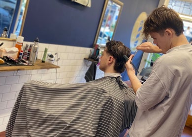 Hair stylist at Indigo Barbers providing a haircut in Auckland, Auckland, NZ.