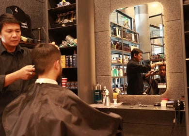 Barber styling client at The Stylish Man | Newmarket in Auckland, Auckland, NZ, featuring sleek decor.