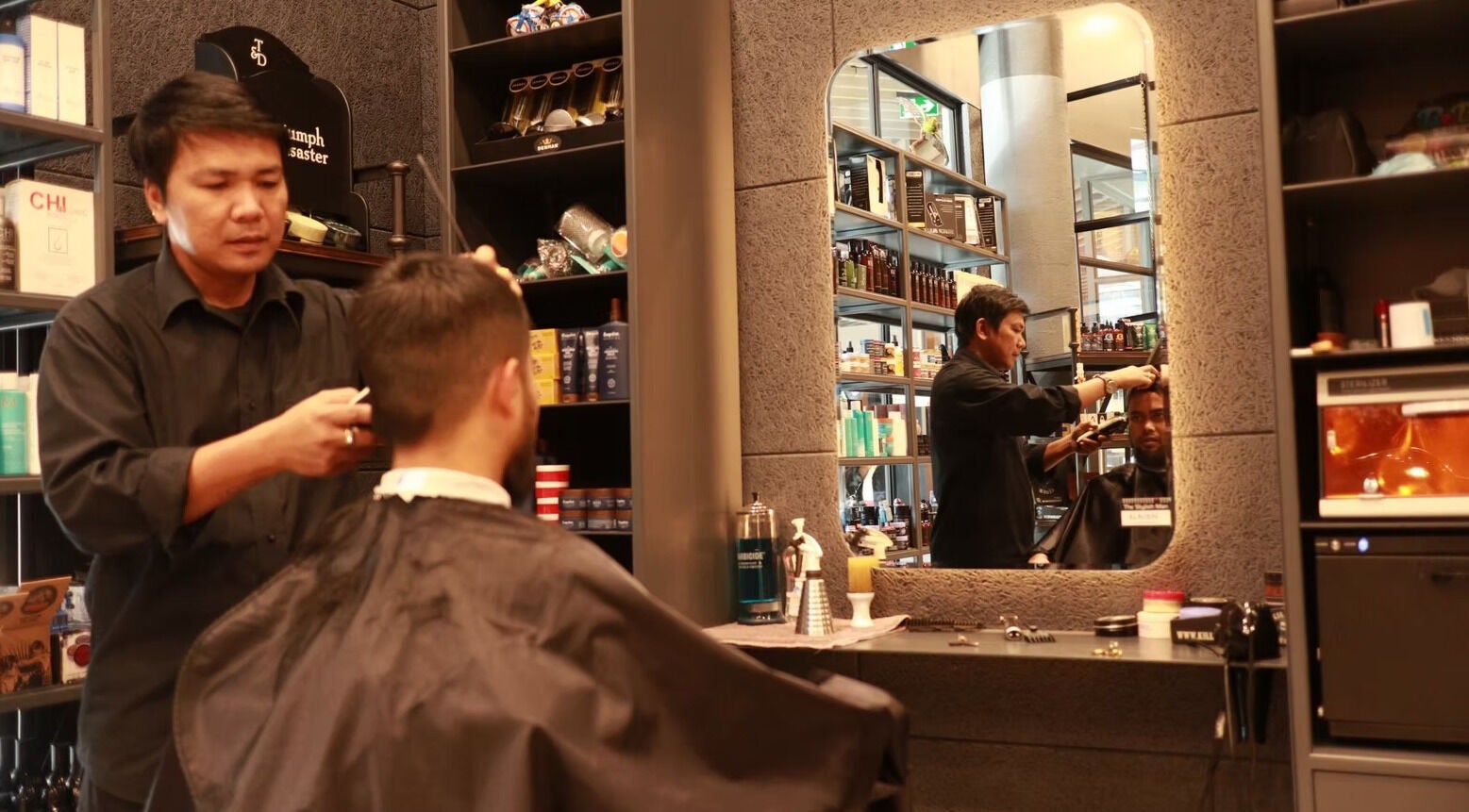 Barber styling client at The Stylish Man | Newmarket in Auckland, Auckland, NZ, featuring sleek decor.