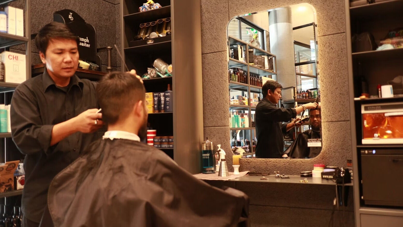 Barber styling client at The Stylish Man | Newmarket in Auckland, Auckland, NZ, featuring sleek decor.