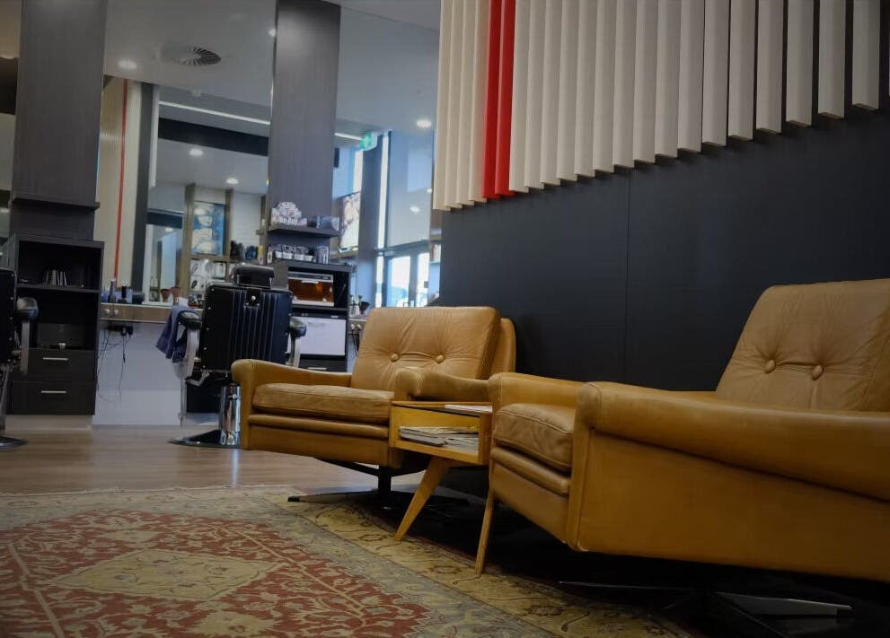 Luxurious lounge area at The Stylish Man | Ponsonby in Auckland, Auckland, NZ, featuring plush leather seating.