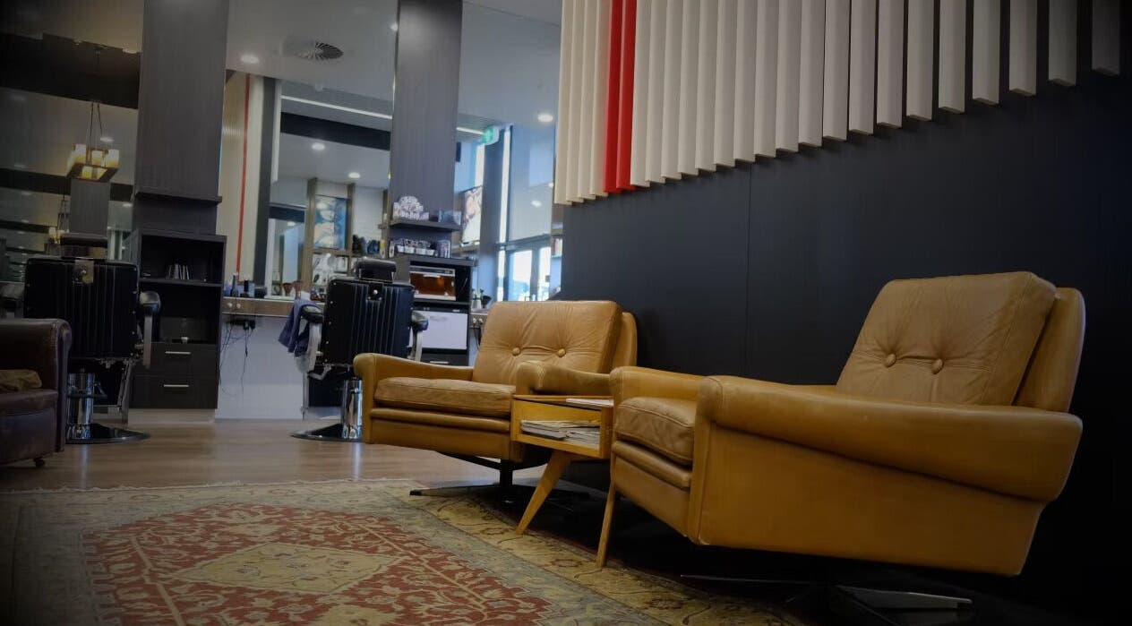Luxurious lounge area at The Stylish Man | Ponsonby in Auckland, Auckland, NZ, featuring plush leather seating.