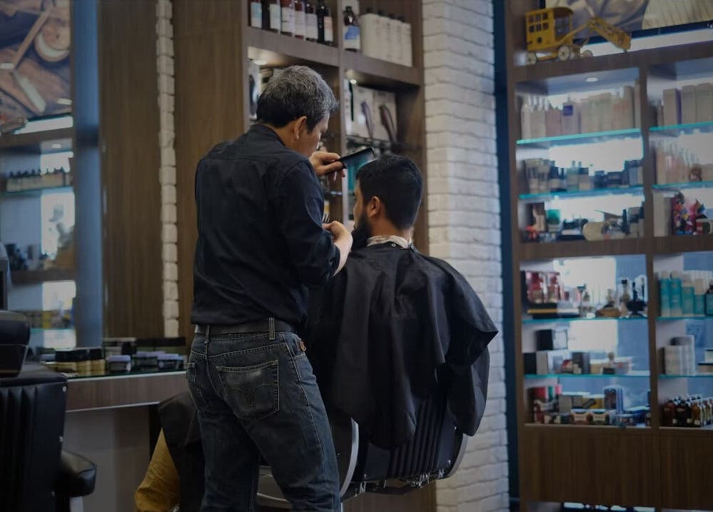 Hair stylist at work in The Stylish Man | Ponsonby, Auckland, Auckland, NZ, surrounded by grooming products.