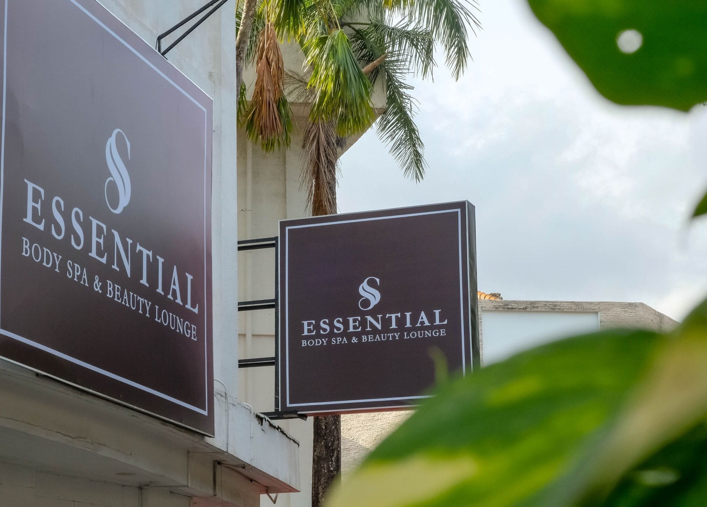 Essential Body Spa & Beauty Lounge exterior sign with lush greenery, located in Bali, Bali, ID.