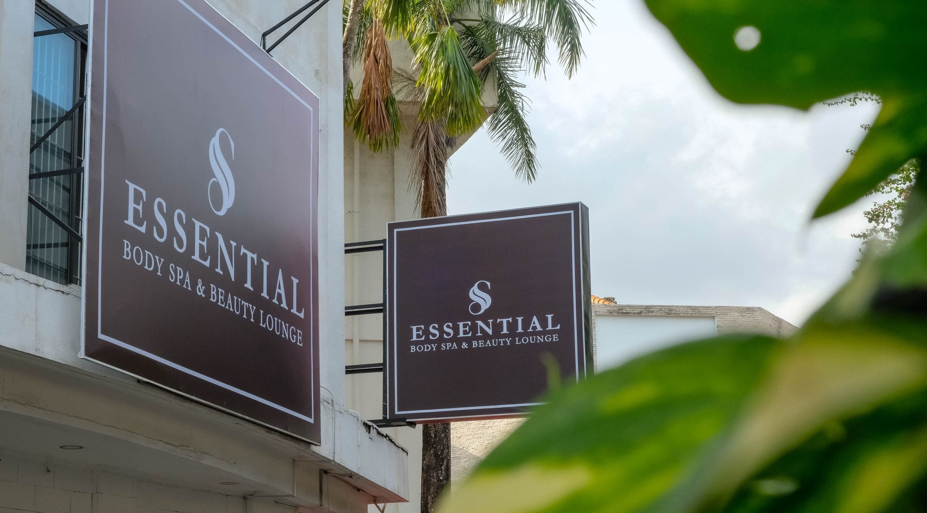 Essential Body Spa & Beauty Lounge exterior sign with lush greenery, located in Bali, Bali, ID.