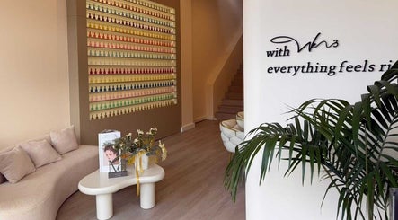 Modern interior of We3 Nails, Hawthorn, Victoria, AU, featuring a stylish waiting area and colorful nail polish display.