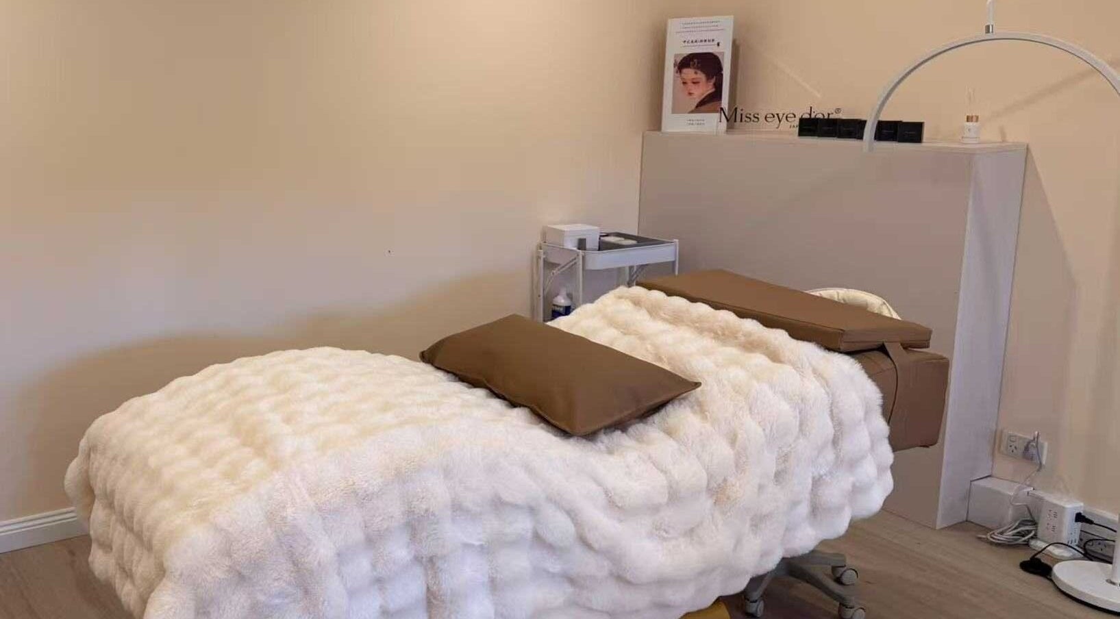 Relaxing spa treatment room at We3 Nails, Hawthorn, Victoria, AU with a cozy white bedspread.