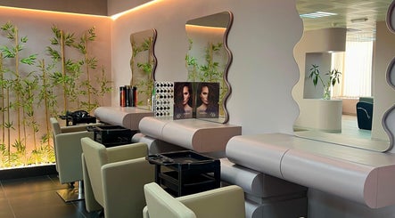 Modern styling chairs and mirrors at WAW Beauty Lounge, Muscat, Muscat Governorate, OM, with lush bamboo decor.
