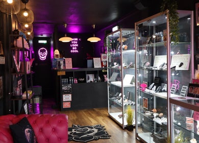 Inside Pierce Me Jessi B, Newark-on-trent, England: modern decor with vibrant neon signs and stylish displays.