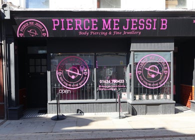 Exterior of Pierce Me Jessi B, a chic piercing venue in Newark-on-Trent, England, GB with pink signage.