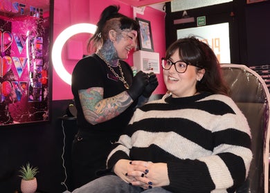 "Pierce Me Jessi B" artist with client smiling in studio, Newark-on-Trent, England, GB