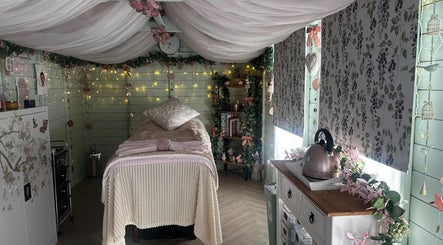 Calming massage room at Serenity View Massage & Beauty, Ashbourne, England, GB with soft lighting and floral decor.