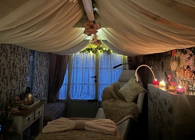 Serenity View Massage & Beauty in Ashbourne, England. Luxurious treatment room with candles and soft drapes.