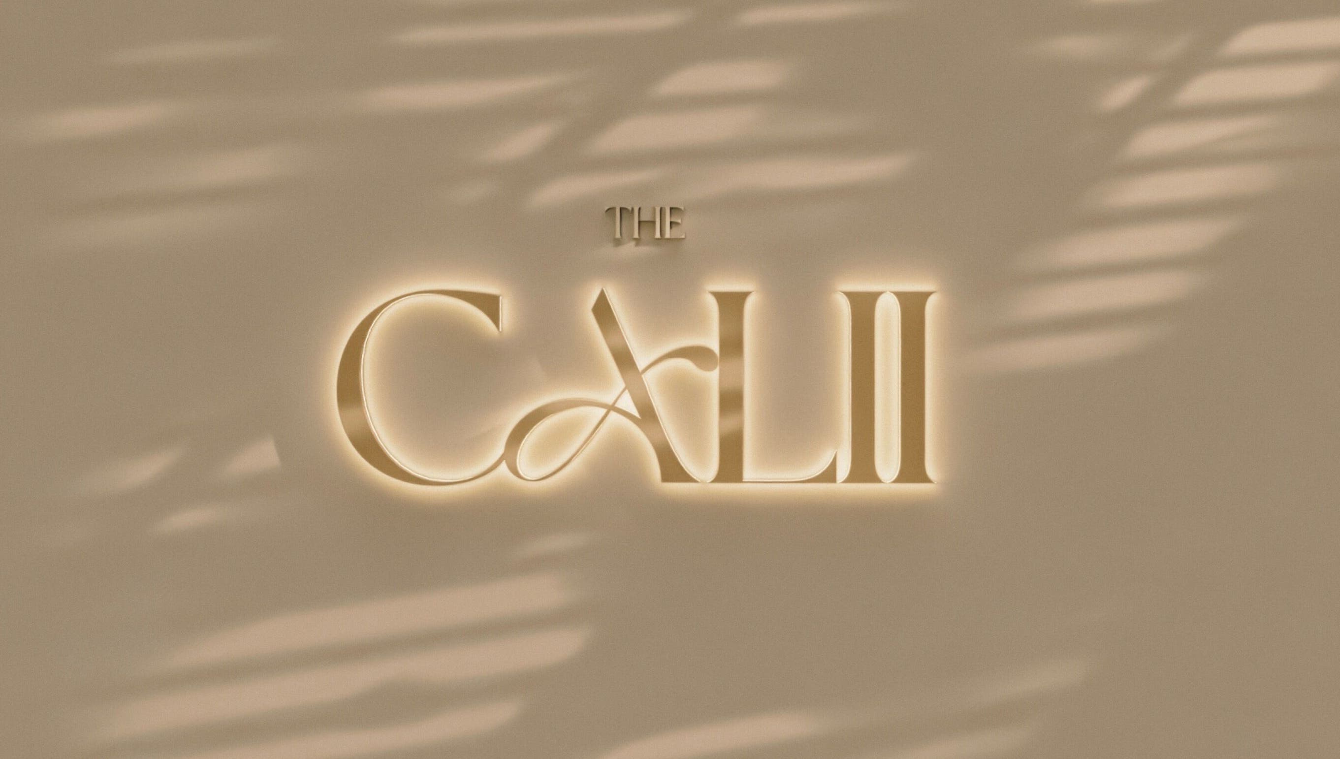 The Calii's elegant illuminated logo on a stylish wall in Wollongong, New South Wales, AU.