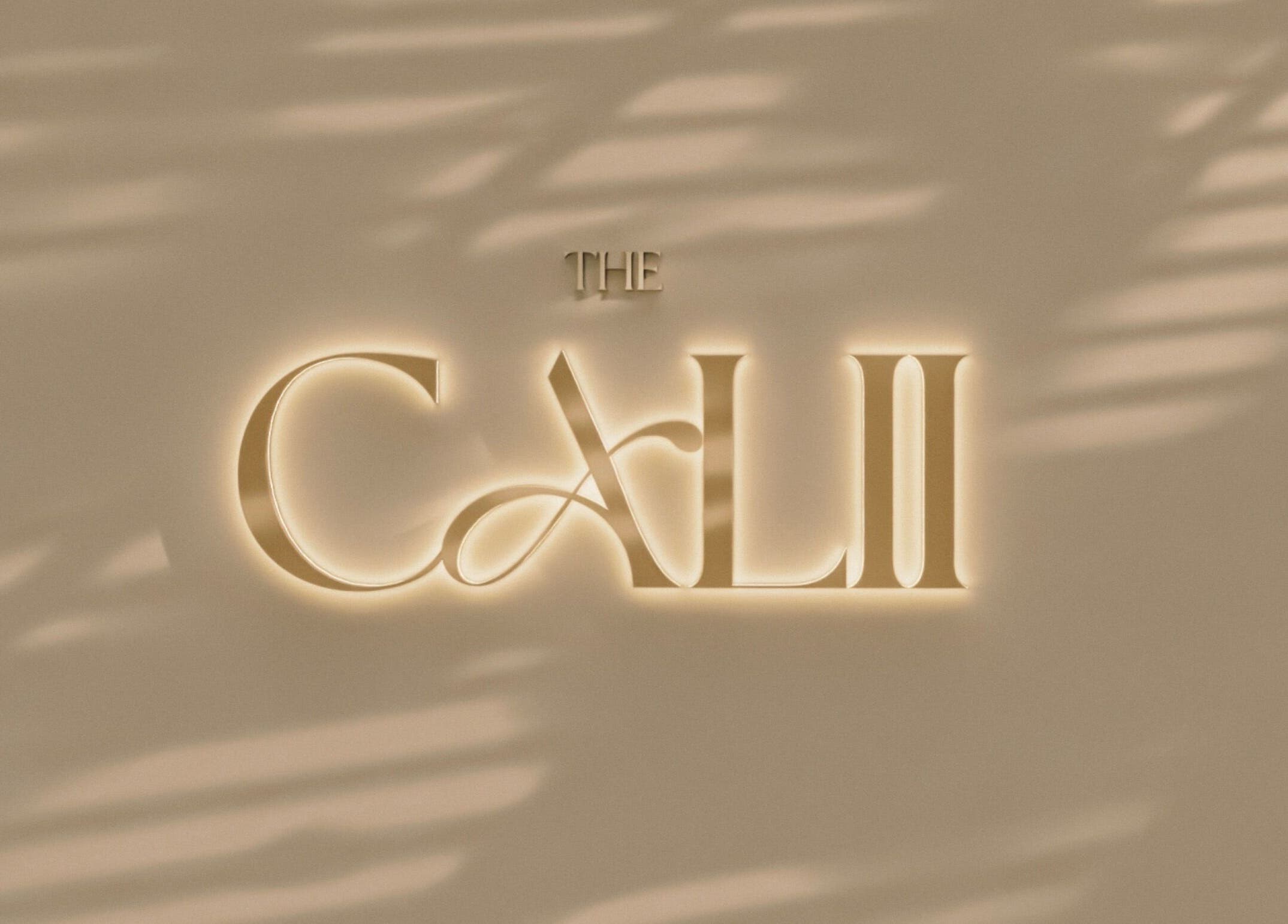 The Calii's elegant illuminated logo on a stylish wall in Wollongong, New South Wales, AU.
