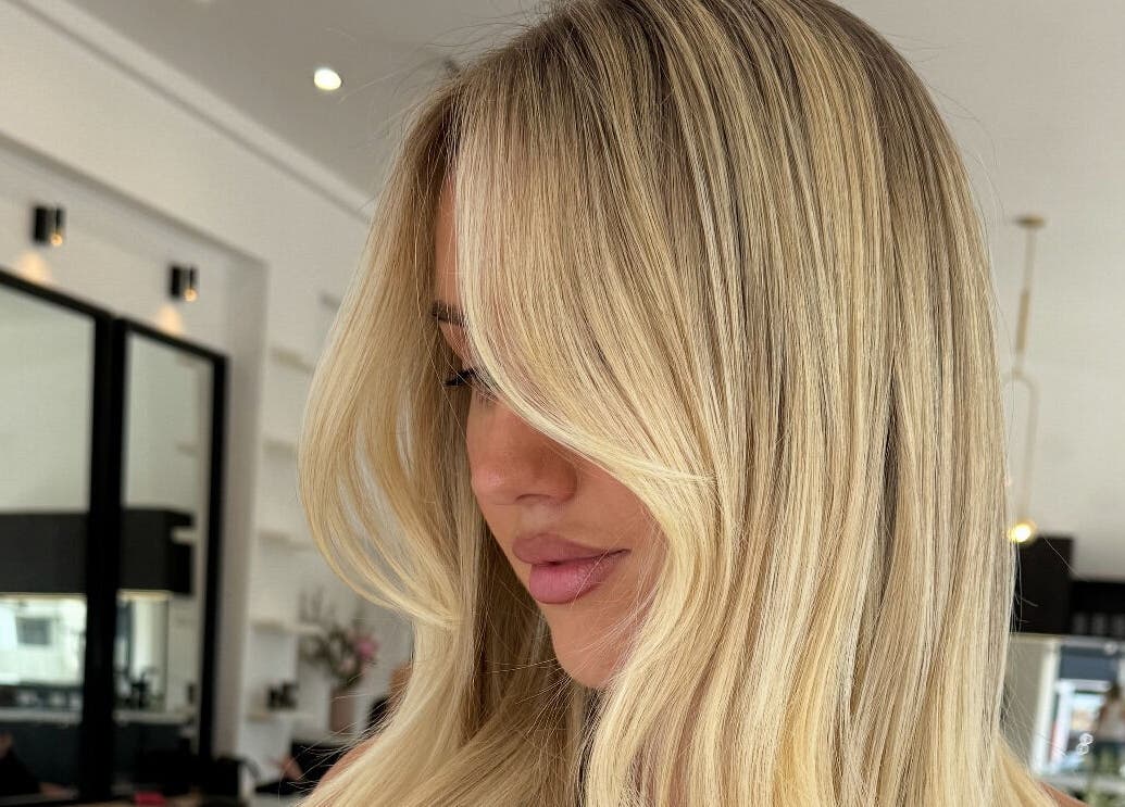 Blonde woman with stylish hair at The Calii, Wollongong, New South Wales, AU salon interior.