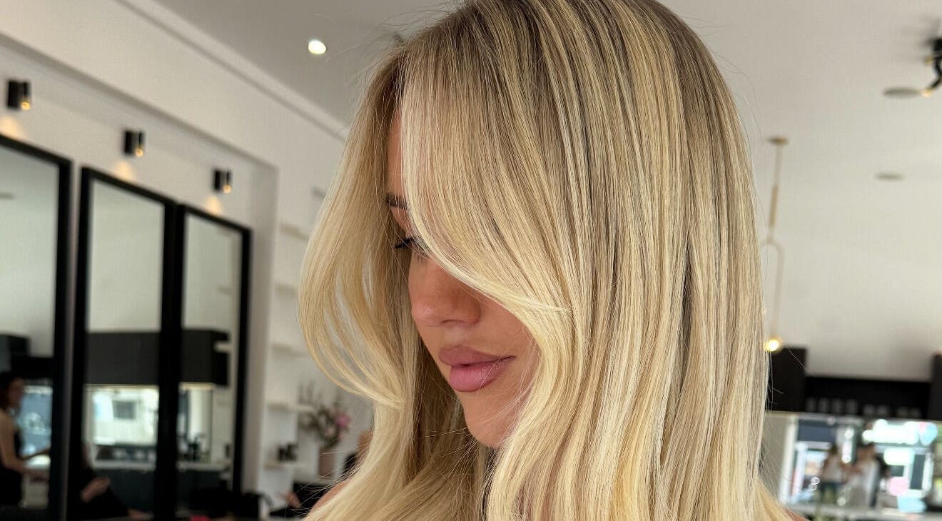 Blonde woman with stylish hair at The Calii, Wollongong, New South Wales, AU salon interior.