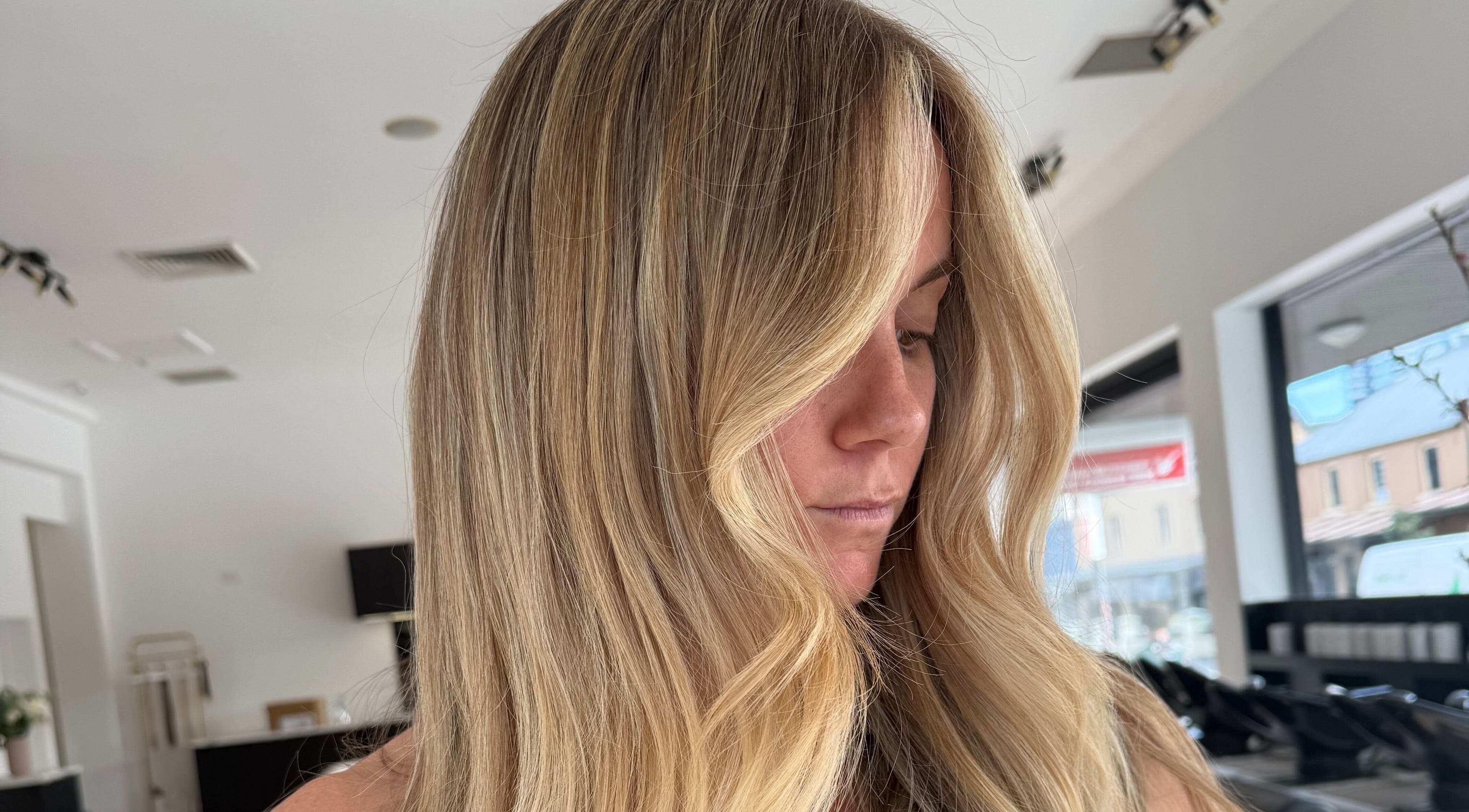 Elegant blonde woman with wavy hair at The Calii in Wollongong, New South Wales, AU.