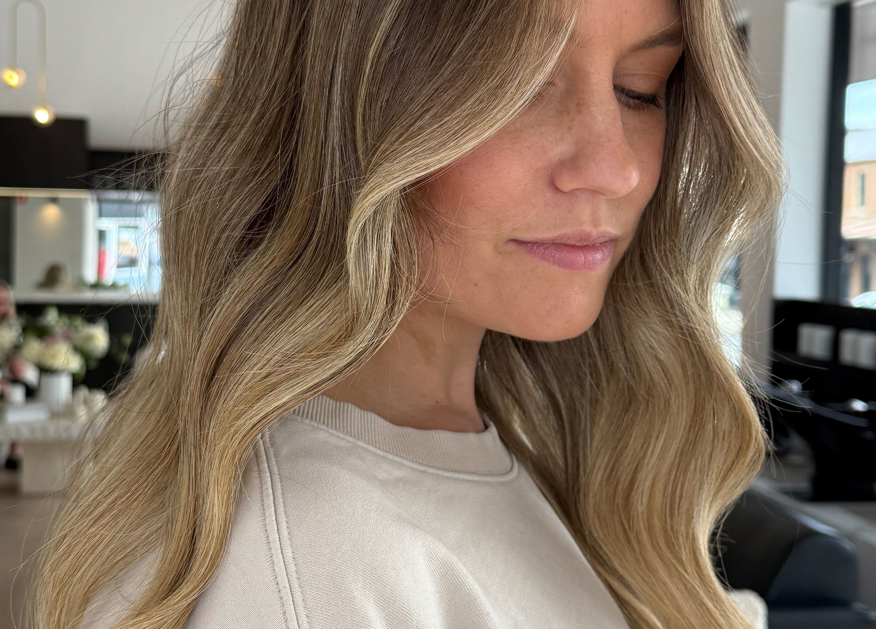 Blonde woman with styled hair at The Calii, Wollongong, New South Wales, AU, showcasing beauty service.