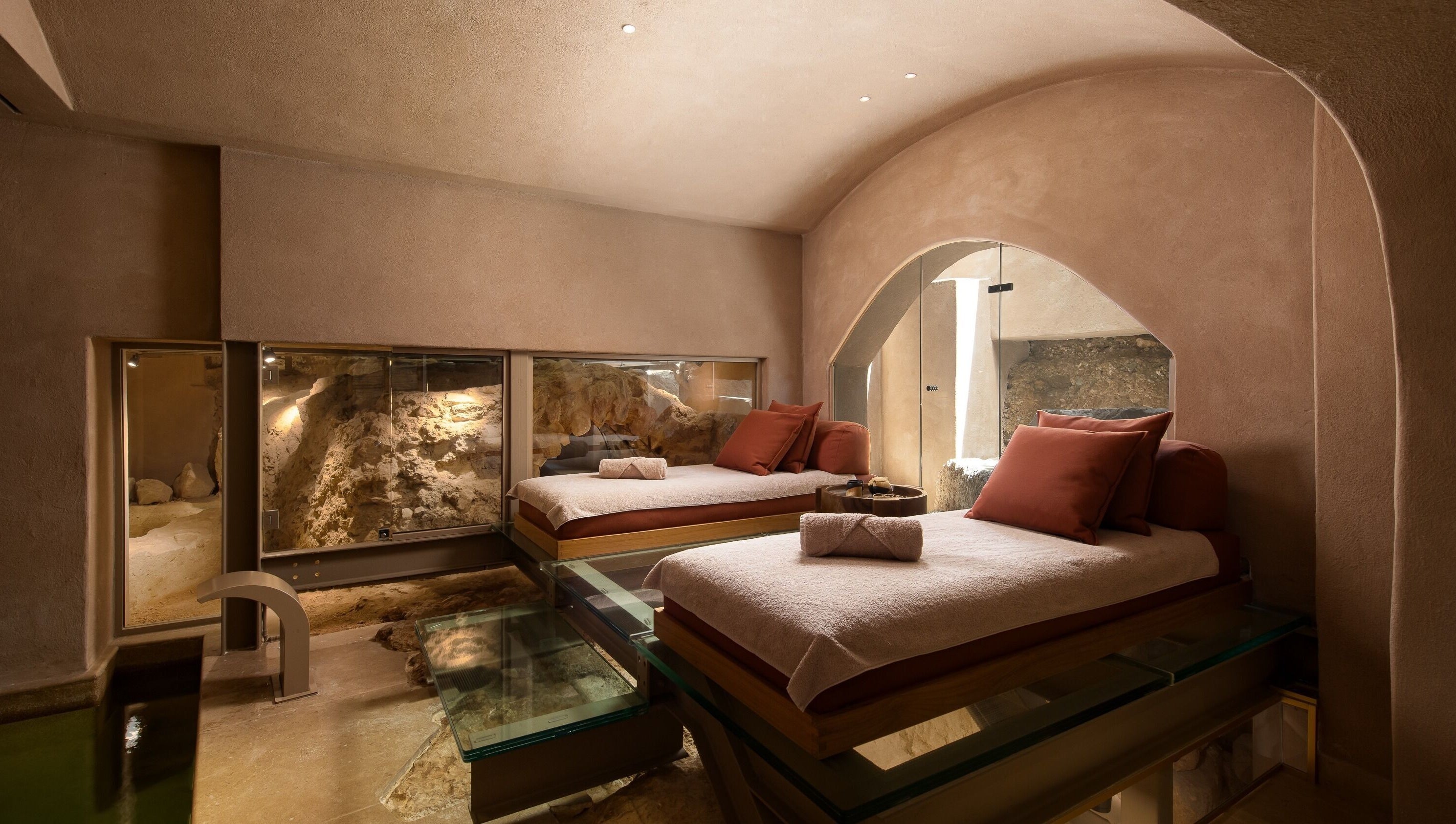 Luxurious therapy beds in a serene cave setting at Niche Spa 300 B.C., Athina, GR.