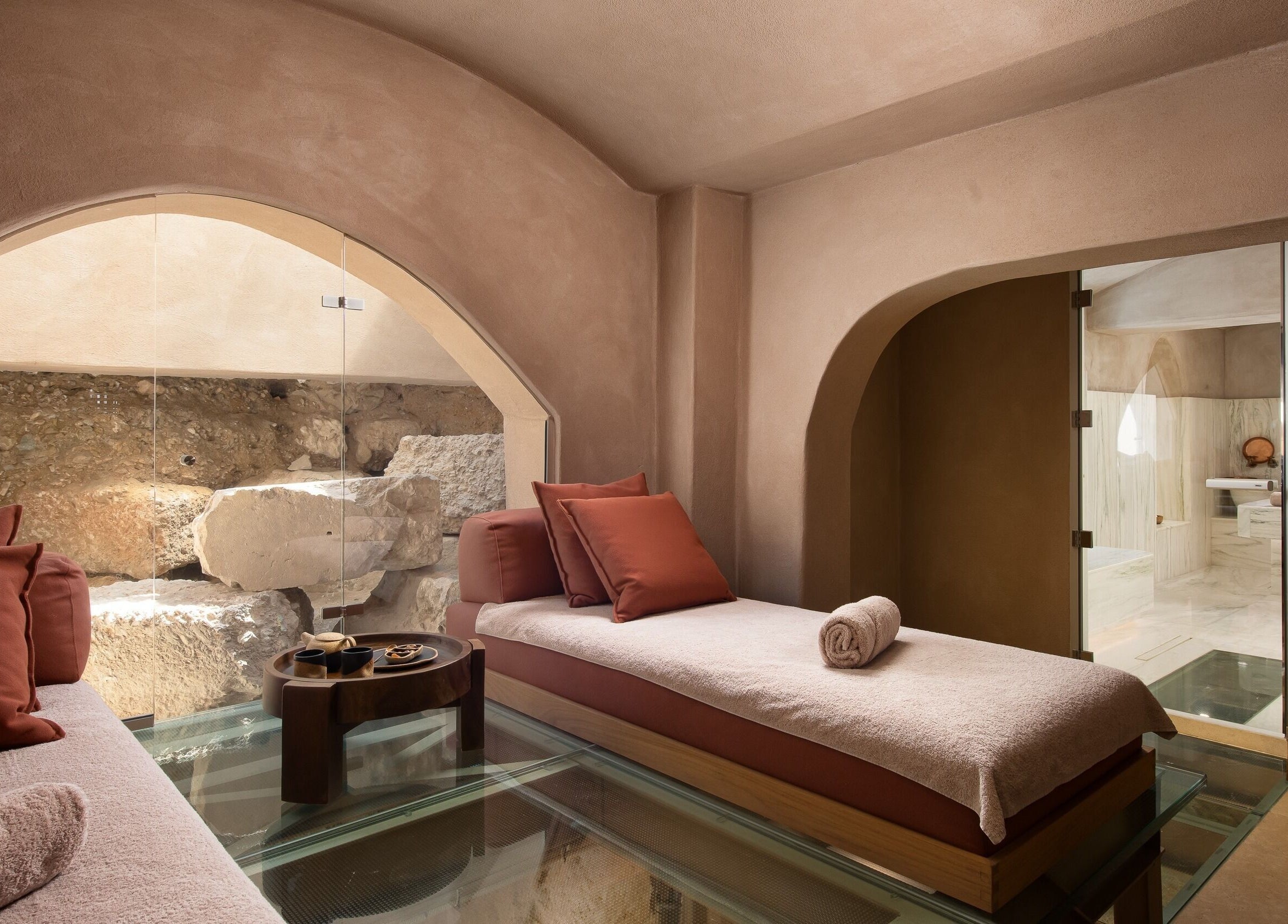 Luxurious spa room at Niche Spa 300 B.C., Athina, GR with elegant loungers and calming decor.
